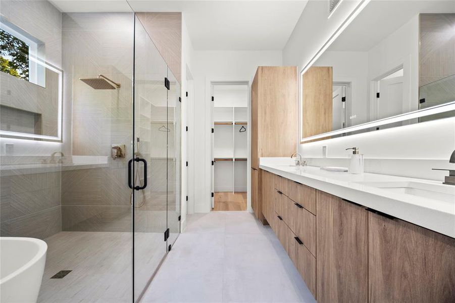 Bathroom with dual bowl vanity, hardwood / wood-style floors, and independent shower and bath