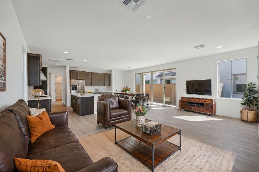 Great room and kitchen; this image has been virtually staged