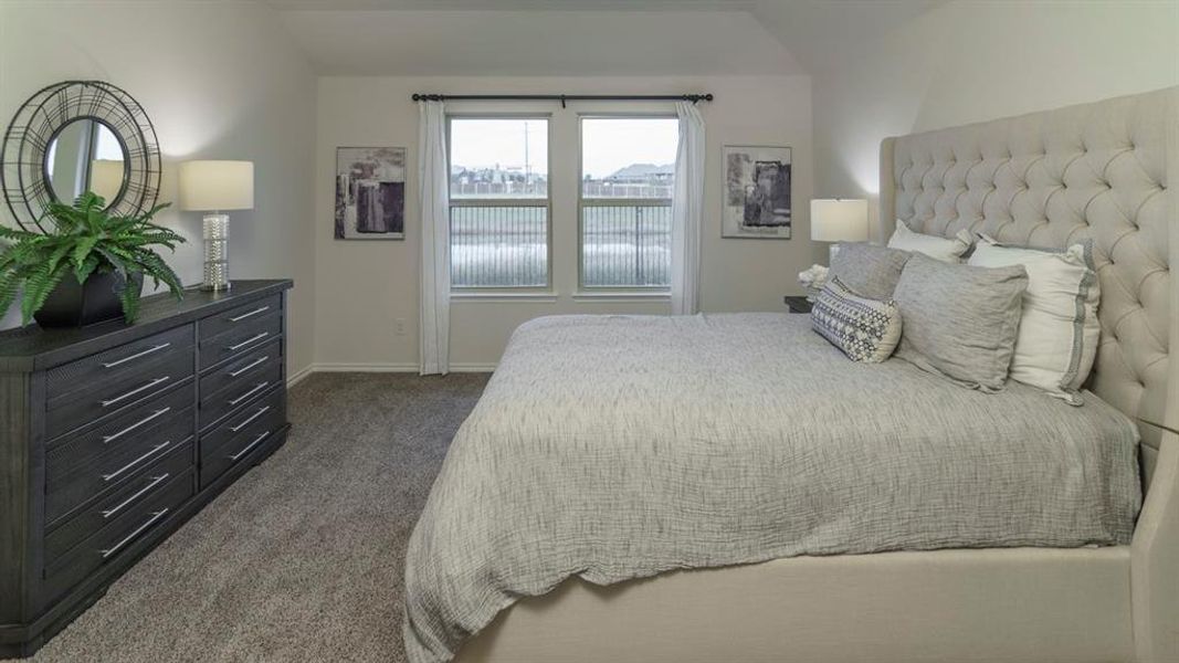Carpeted bedroom featuring neutral walls and a vaulted ceiling Carpeted bedroom featuring neutral walls and a vaulted ceiling