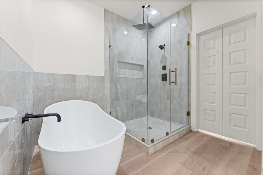 The primary bath is full of options including dual vanities, a large soaking tub and a 6'x4' shower with both a rain head and wall-mount shower fixtures.