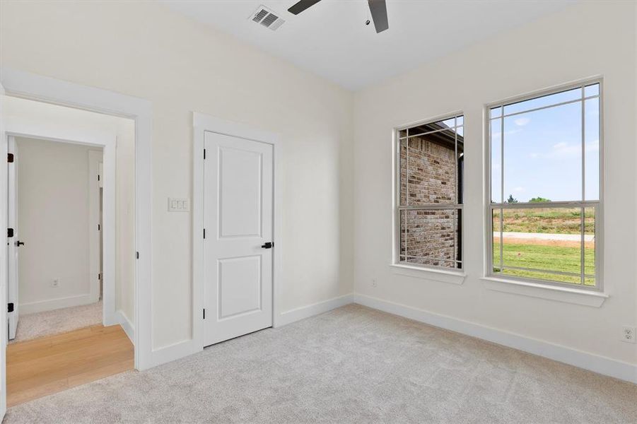 Unfurnished bedroom featuring carpet floors, baseboards, and a ceiling fan Unfurnished bedroom featuring carpet floors, baseboards, and a ceiling fan