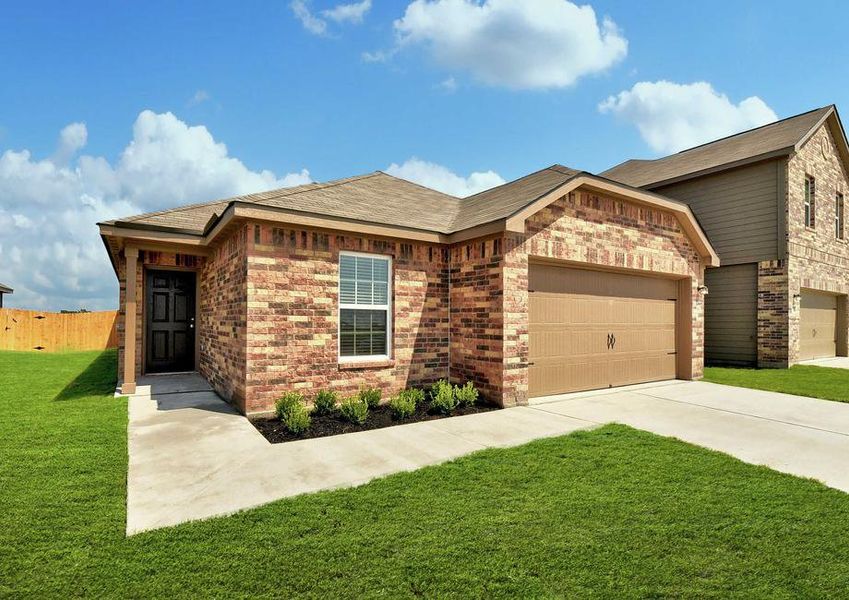 Medina single-family home with green landscaped yard, brick finish siding, and brown two car garage door