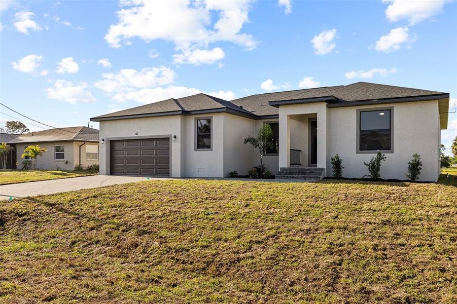 Front exterior of a new home in , Rotonda West, FL, highlighting curb appeal (Image 25).