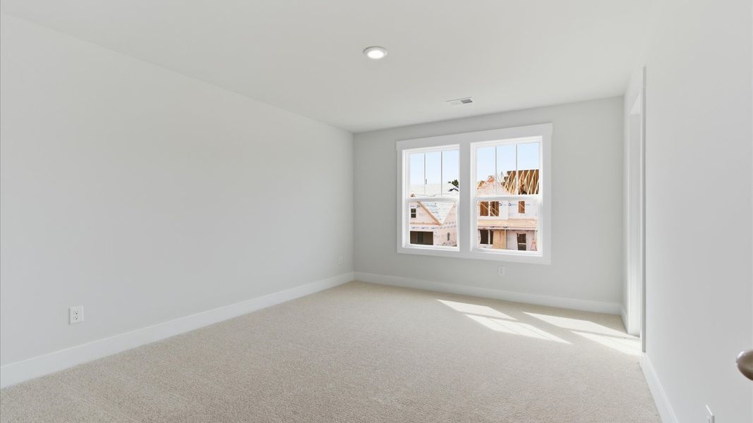 Elegant bedroom retreat featuring soft carpet and oversized windows that create a bright, welcoming space at Foxbank