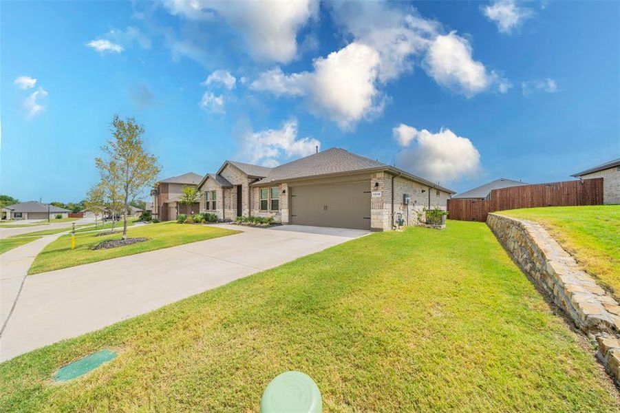 Ranch-style house with a garage and a front yard