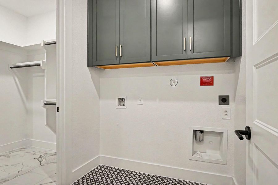 Laundry room upgraded with built-in cabinets. Has separate entrance to primary closet. Laundry room upgraded with built-in cabinets. Has separate entrance to primary closet.