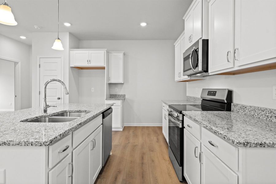 The Dove- Kitchen. Home under construction, photo used for illustrative purposes only, colors and options will vary.