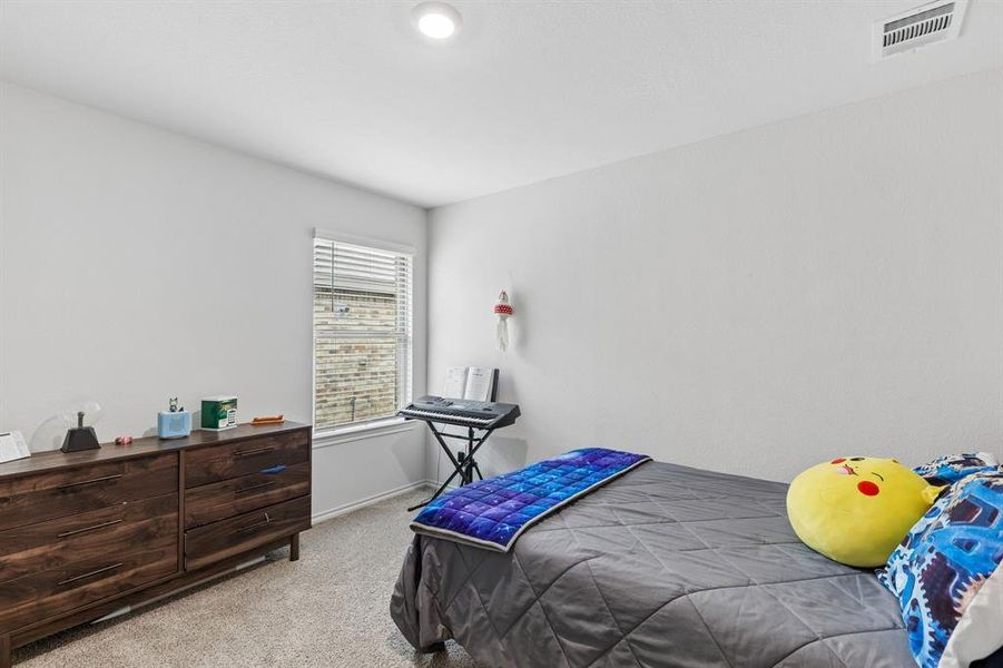 Bedroom with light carpet and baseboards Bedroom with light carpet and baseboards