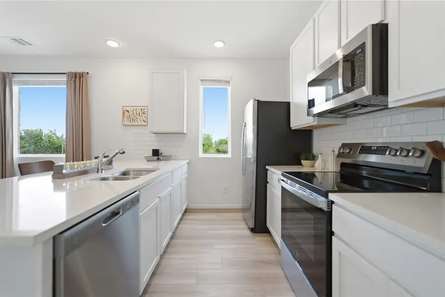 Representative furnished interior of a home built from the Kahn by CastleRock Communities in Municipal Drive Townhomes, Leander (Image 13).