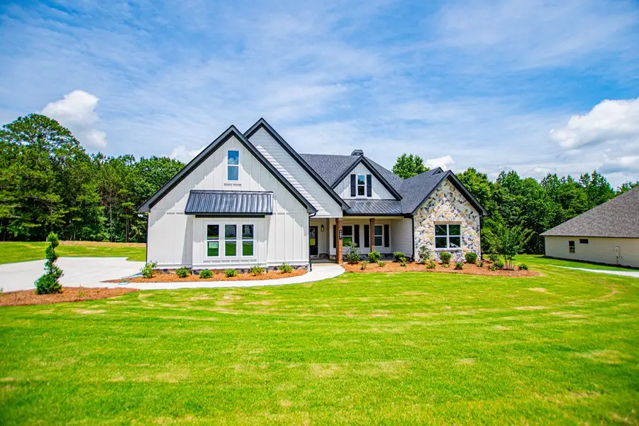 Front exterior of a new home in WOODMONT RESERVE, Roopville, GA, highlighting curb appeal (Image 28).