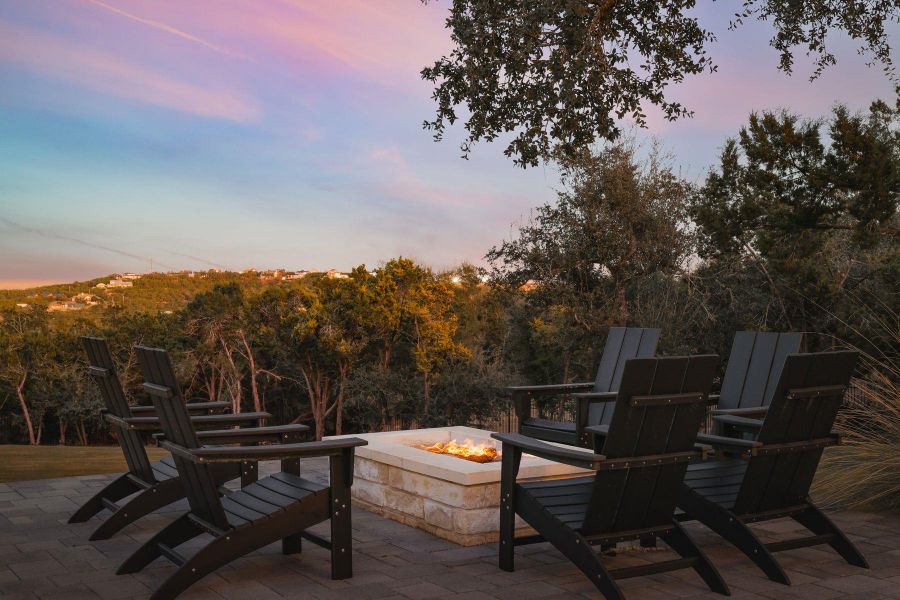 Patio terrace at dusk with a fire pit Patio terrace at dusk with a fire pit