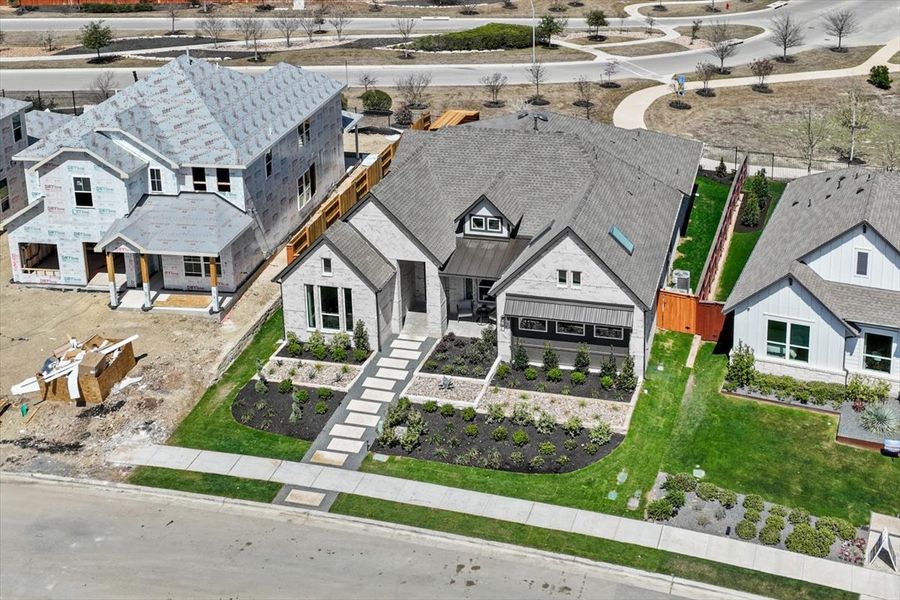 Front exterior of a new home in Sunfield, Buda, TX, highlighting curb appeal (Image 3). Front exterior of a new home in Sunfield, Buda, TX, highlighting curb appeal (Image 3).