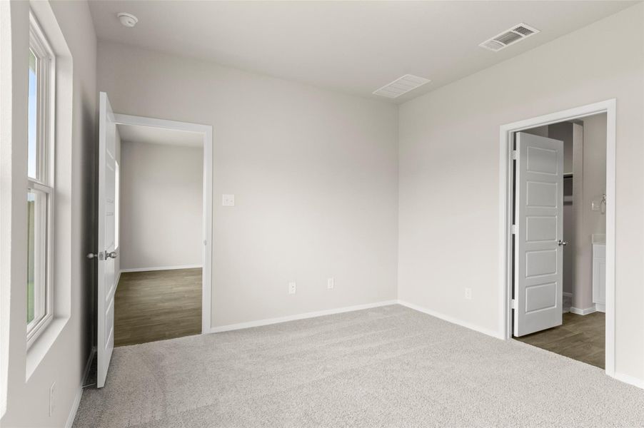 Unfurnished bedroom featuring carpet and baseboards