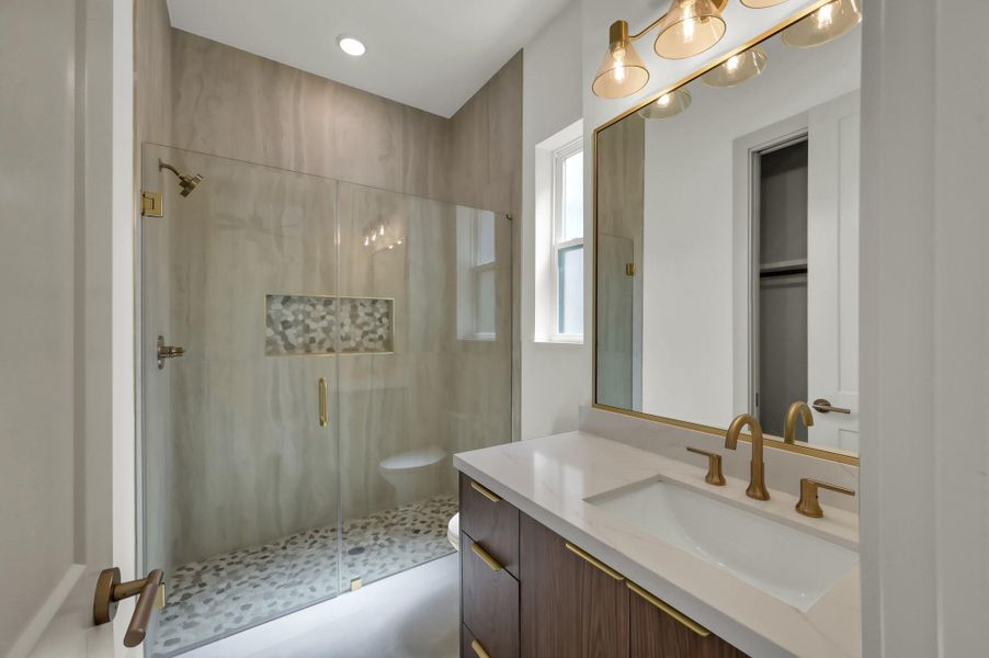 Beautifully finished bathrooms combine clean design with quality materials, creating cohesive and elevated spaces throughout the home.