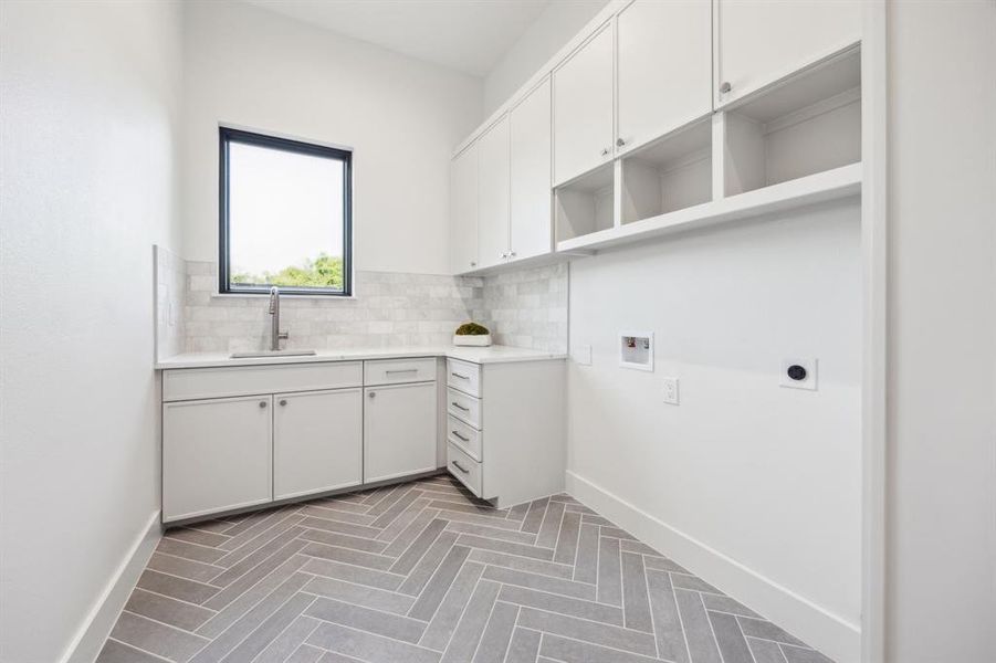 Downstairs oversized laundry room with great storage and sink. Downstairs oversized laundry room with great storage and sink.
