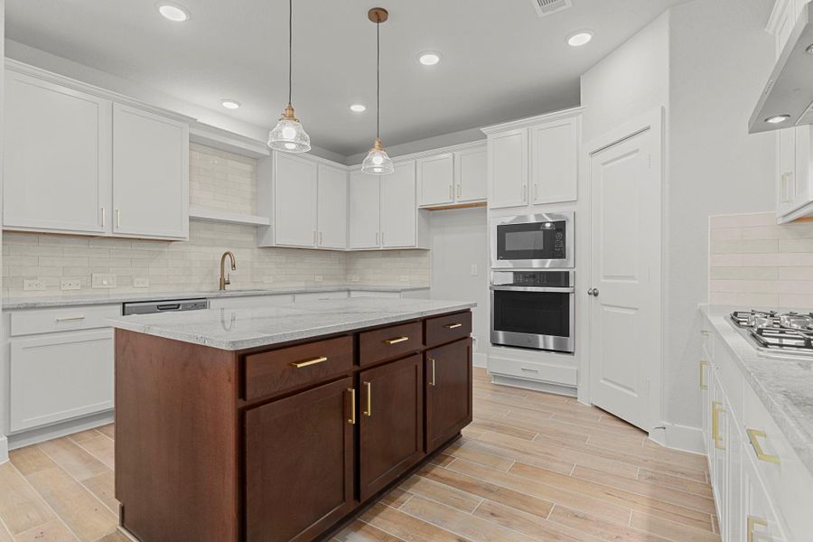 Another view of this chef-inspired kitchen highlights the generous counter space, built-in microwave, oven, stainless steel appliances, and spacious layout—perfect for both everyday living and hosting guests. Another view of this chef-inspired kitchen highlights the generous counter space, built-in microwave, oven, stainless steel appliances, and spacious layout—perfect for both everyday living and hosting guests.