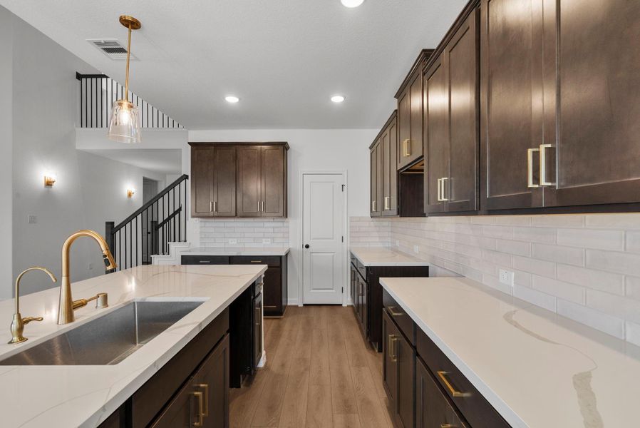 Kitchen has plenty of countertop space and a walk in pantry.