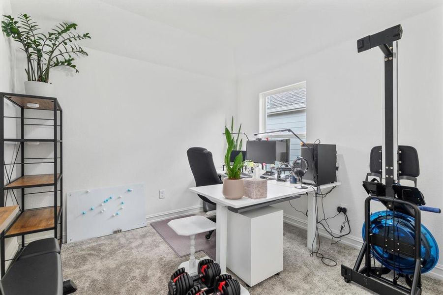 Office area featuring light carpet