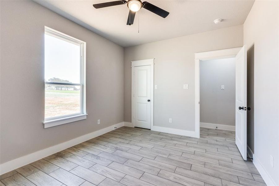 Unfurnished bedroom featuring light hardwood / wood-style floors and ceiling fan