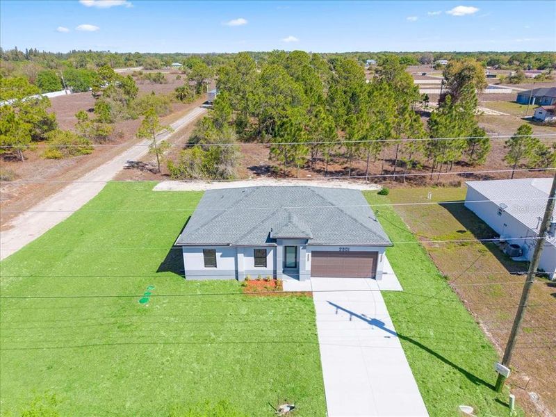 Front exterior of a new home in , Lehigh Acres, FL, highlighting curb appeal (Image 8).