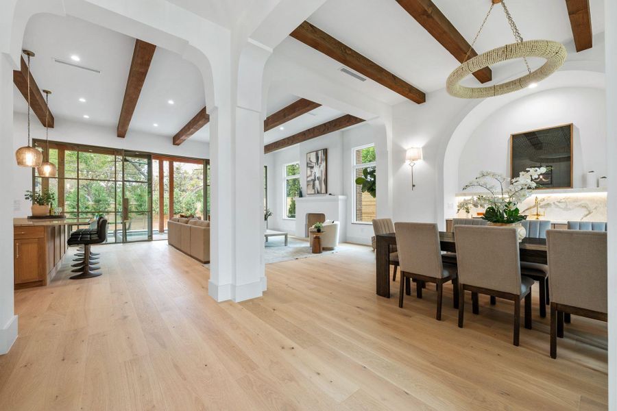 Dining room with beamed ceiling, light wood finished floors, and recessed lighting Dining room with beamed ceiling, light wood finished floors, and recessed lighting