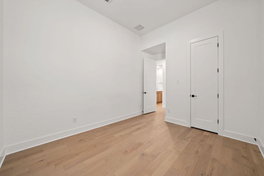 Unfurnished bedroom with light wood-style flooring and baseboards