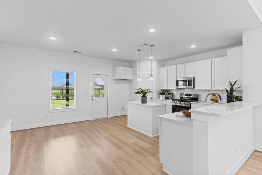 A generous dining area just off the kitchen provides the perfect spot for casual meals or formal gatherings, with windows that offer tranquil views and seamless connection to the outdoor living space. **Image Representative of Plan Only and May Vary as Built**.