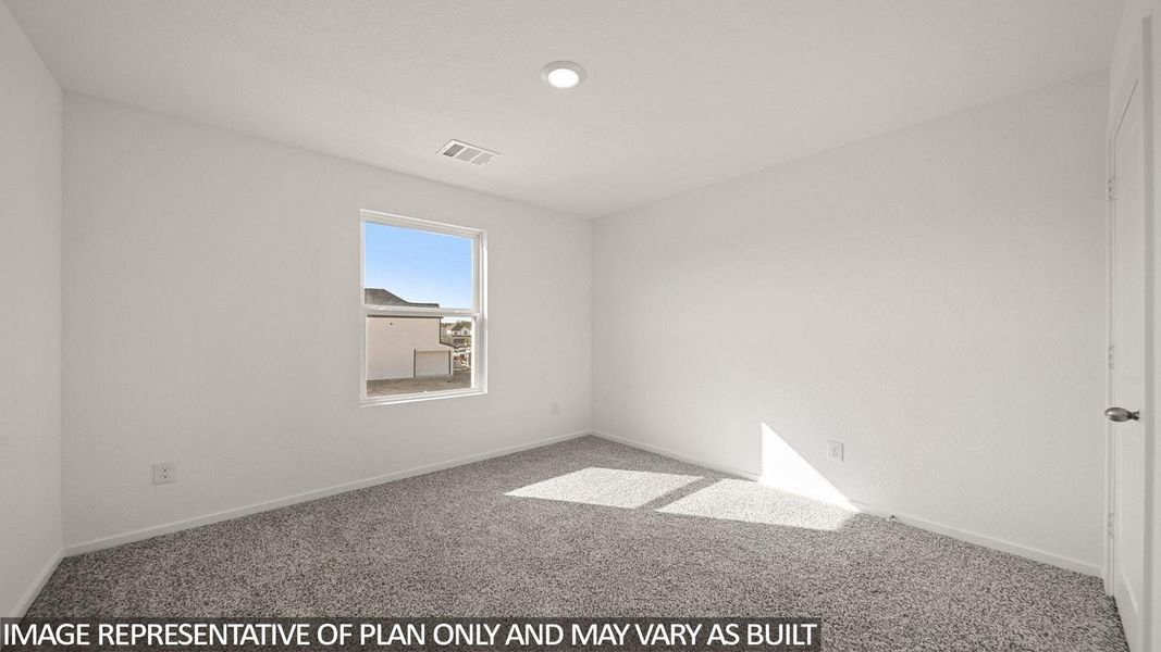 Neutral-toned carpeting paired with white walls, a single window, and a recessed ceiling light