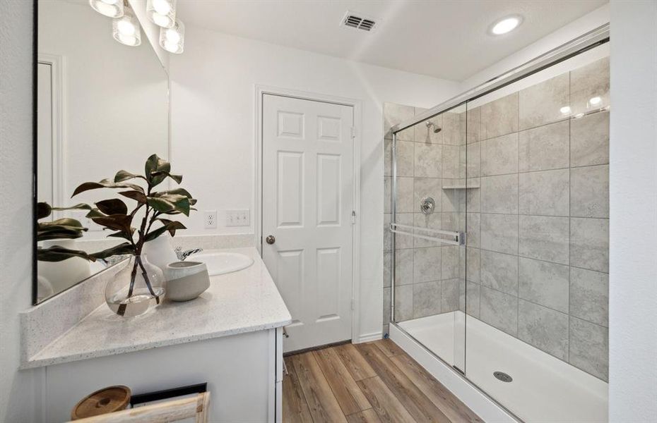 Deep walk-in shower designed for relaxation in the owner's bath *Model representation