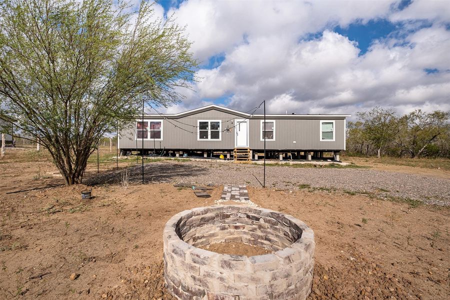 View of front of property with an outdoor fire pit