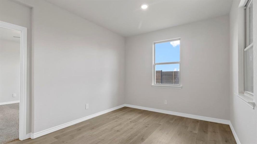 Unfurnished room featuring baseboards and light wood-type flooring
