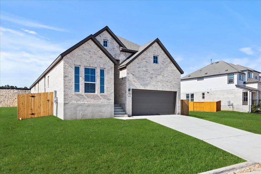 Front exterior of a new home in Meyer Ranch, New Braunfels, TX, highlighting curb appeal (Image 19).
