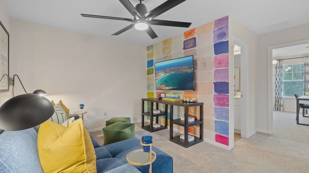 Spacious upstairs loft in new construction townhome for flexible office or lounge use at Auburn Ridge in Riverdale, GA.
