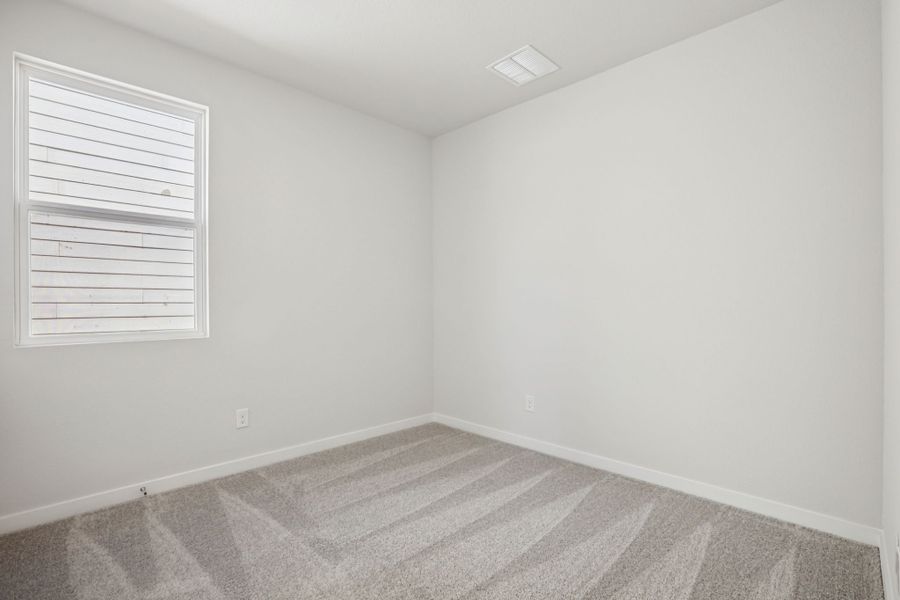 A room with a rug and a window. A room with a rug and a window.