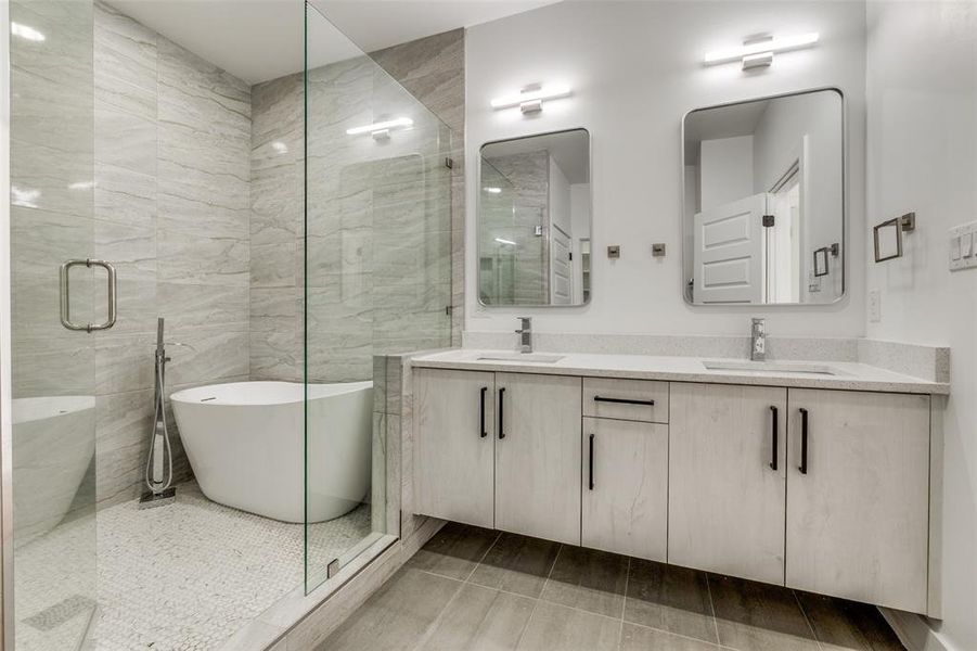 Primary bathroom featuring a spa shower, double vanity, a sink, and a soaking tub. Separate Toilet and Walkin Master closeet
