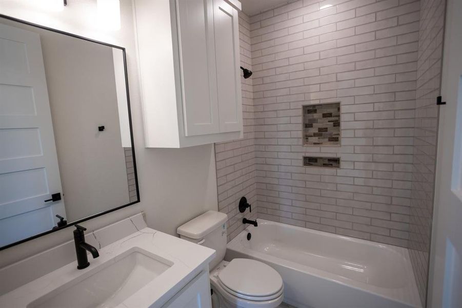 Bathroom featuring bathtub / shower combination and vanity Bathroom featuring bathtub / shower combination and vanity