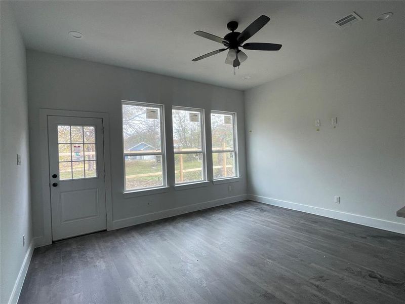 Spare room with dark hardwood / wood-style flooring and ceiling fan