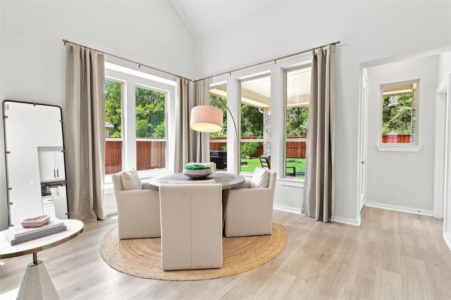 Dining space clothed in natural light. Window seat to the left