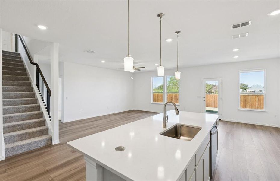 Large island overlooking gathering room and dining areas Large island overlooking gathering room and dining areas