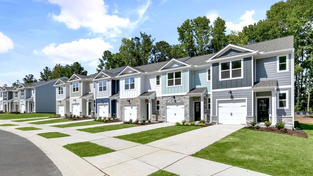 Front exterior of a new home in The Townes at Bexford, Willow Spring, NC, highlighting curb appeal (Image 21).