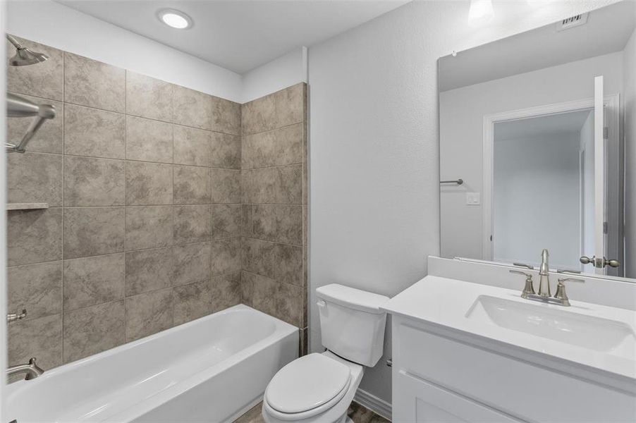 Full bathroom with shower / washtub combination, vanity, and recessed lighting