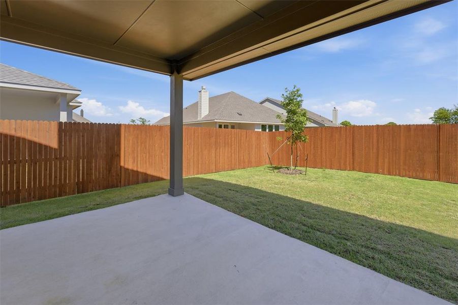 Fenced backyard with a patio