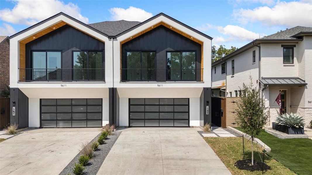 Contemporary house featuring a balcony, concrete driveway, an attached garage, brick siding, and a standing seam roof Contemporary house featuring a balcony, concrete driveway, an attached garage, brick siding, and a standing seam roof