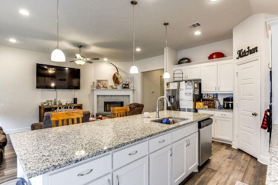 The kitchen includes a massive island, stainless steel appliances and a walk in pantry.