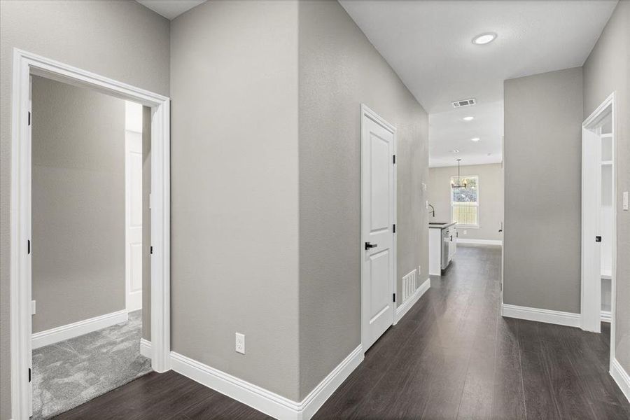 Hallway with dark wood-type flooring and sink