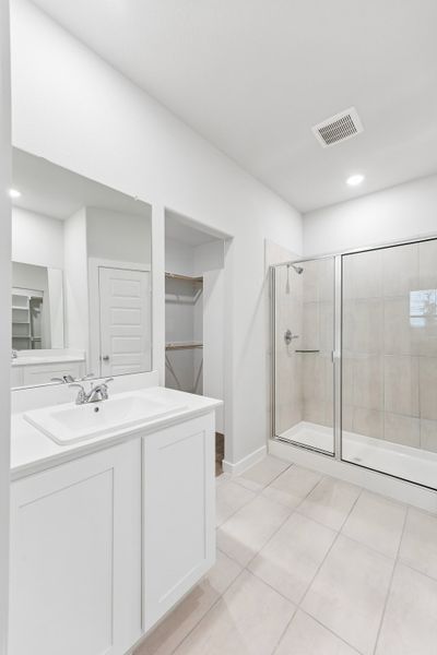 Primary Bathroom in the Cedar home plan by Trophy Signature Homes – REPRESENTATIVE PHOTO
