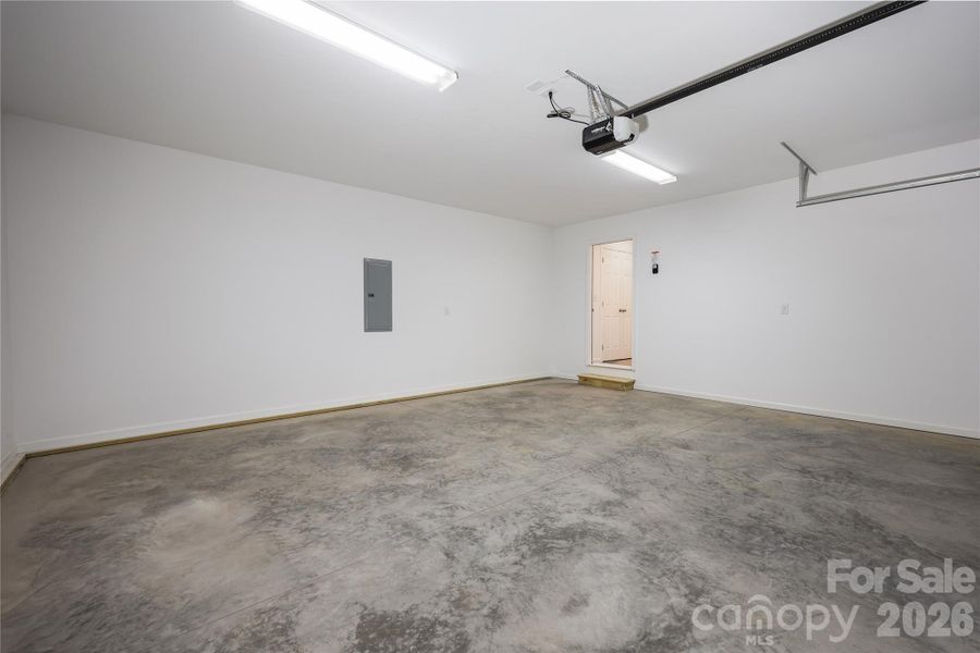 Inside of garage with entrance to home