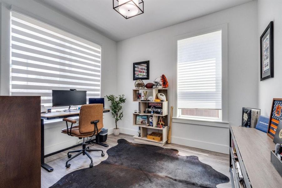 Office space with wood finished floors and plenty of natural light