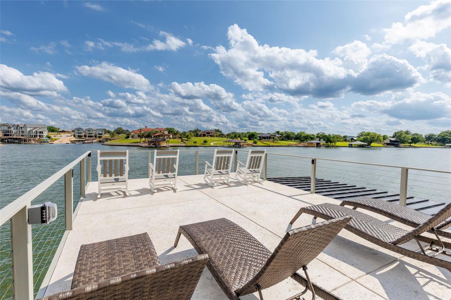 2-slip boat dock with party deck for lakeside fun. 2-slip boat dock with party deck for lakeside fun.