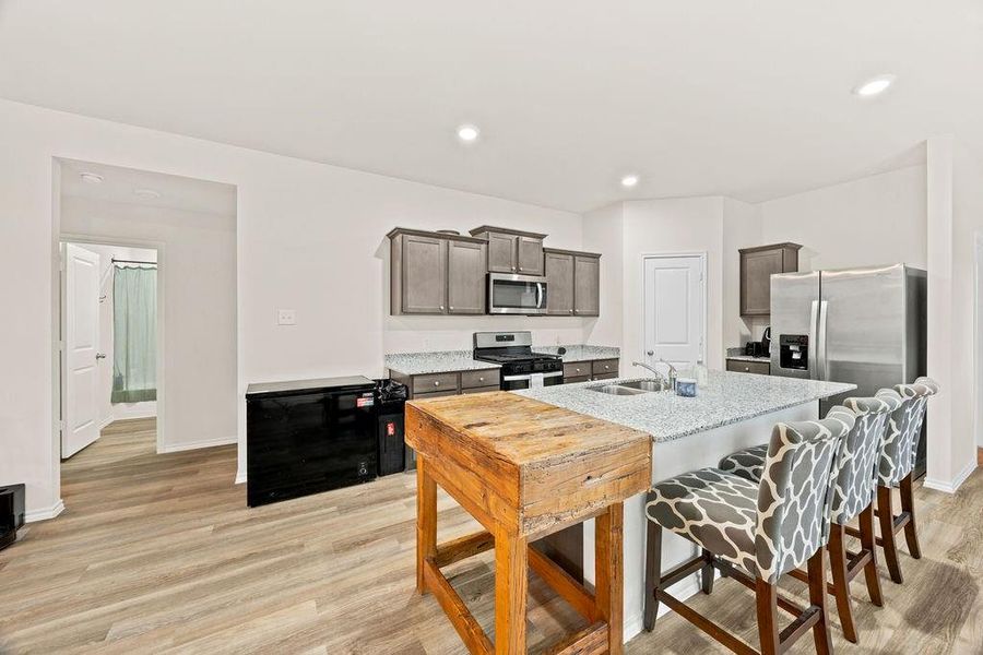 Kitchen featuring light wood-finish flooring and recessed lighting Kitchen featuring light wood-finish flooring and recessed lighting
